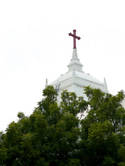 White facade of Zion Church with a cross atop and trees in Tharangambadi, Tamil Nadu, a historic Danish colonial-era Protestant church.