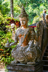 Obraz premium Intricate four-armed deity statue at the Wat Pha Lat forest temple in Chiang Mai, Northern Thailand