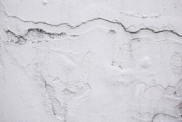 White concrete wall with cracks and scratches. Landscape style. Great background or texture.