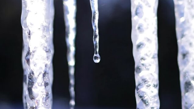A video showcasing icicles melting in a dramatic and serene winter scene