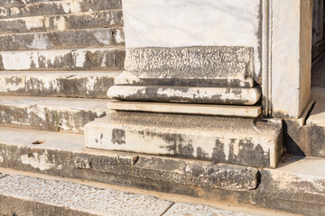 Ancient stone steps with weathered marble details and sunlit shadows