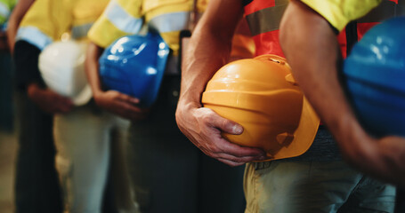 Group, line and hands with helmet in warehouse for freight safety regulations or shipping cargo. People, supplier team or distributor in row with hard hat for maintenance or supply chain service © BuyOutFelix06/peopleimages.com