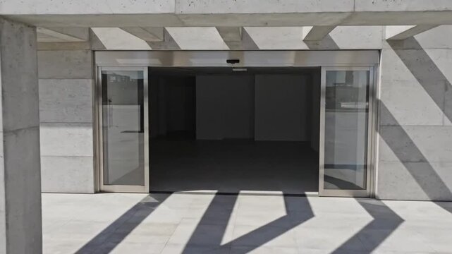 Automatic Sliding Glass Doors Opening and Closing in Modern Building Entrance.