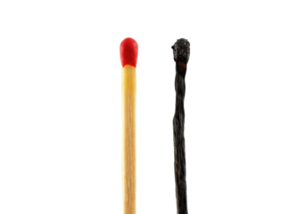 Pristine unlit red matchstick juxtaposed with a burnt-out charred one on a white background. Concept of burnout, exhaustion and contrast