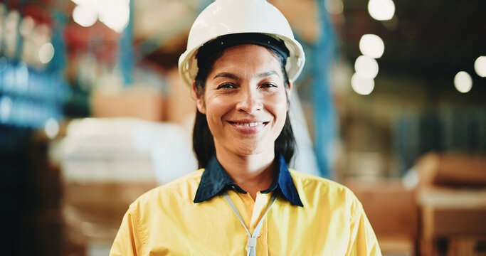 Happy woman, portrait or contractor with helmet in warehouse for shipping, logistics or storage. Female person, distributor or supplier with smile for freight, cargo distribution or inventory service