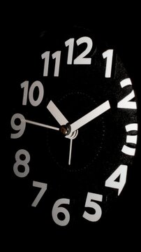 Tme lapse video of a clock time passing over a day to night on black background.