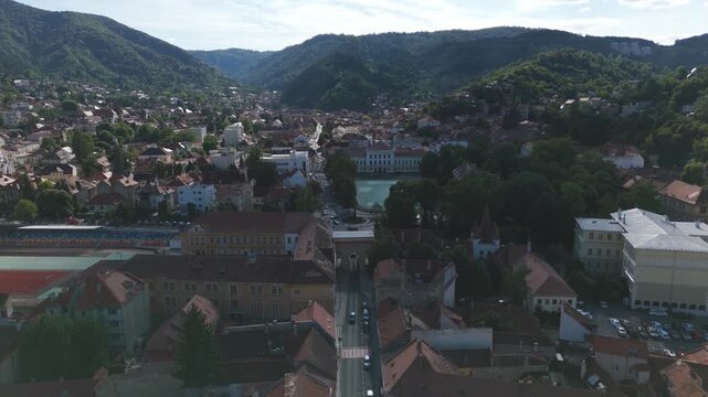 Aerial view pulling away from the iconic Șchei Gate, highlighting its role as a historic entrance to Brașov.