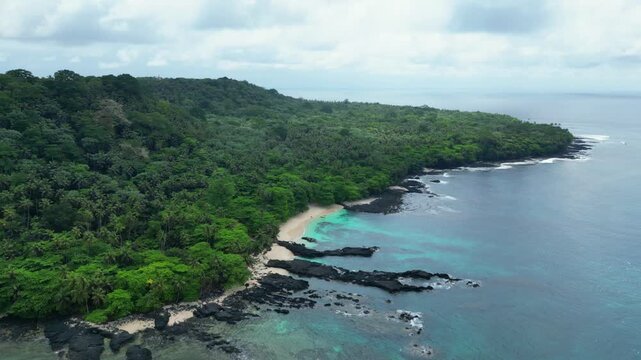 Aerial view from ilheu das Rolas, a islet in the archipelago of S&atilde;o Tom&eacute;,located in the Gulf of Guinea, south of the island,volcanic origin, it lies directly on the Equator Line. Drone shot backwards.
