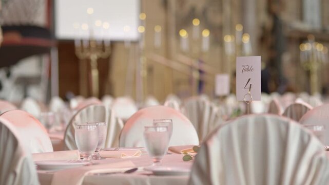Making a big speech at a fancy wedding venue - microphone in front of set tables