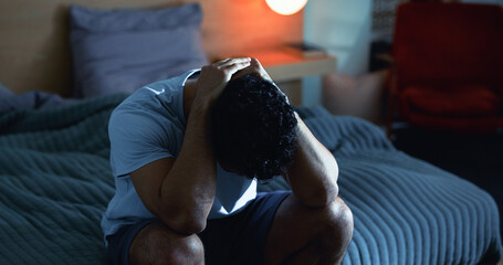 Insomnia, night and man in bedroom with stress for burnout, exhausted and fatigue for mental...