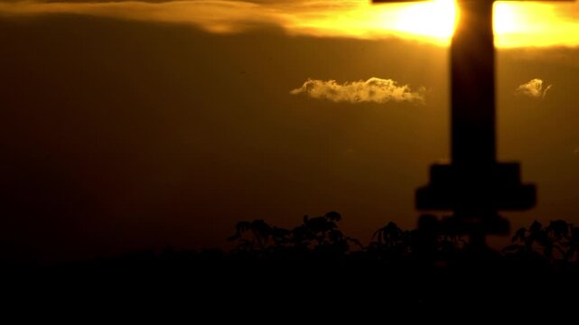 Cross with light beam through the cloud 
