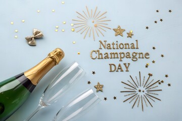 Celebrating national champagne day with a golden bottle two empty flutes and sparkling holiday decorations arranged beautifully on a light blue surface for festive cheer