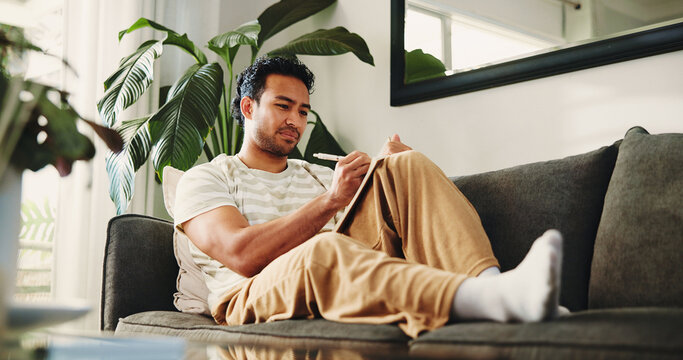 Man, journal and writing on couch in house, daily reflection or idea notes to relax for creativity. Person, notebook for planning or sketching with agenda in diary, to do list or goal setting in home