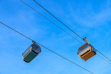 Obraz premium Two cable car gondolas on blue sky in Nha Trang, Vietnam