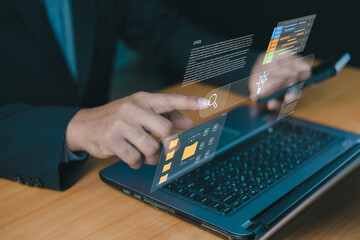 Businessman using laptop with virtual screen interface for file management and data searching. Digital technology concept for document organization, cloud storage access, online workflow efficiency.