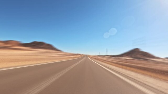 Time lapse car driving through wide desert valley on straight asphalt highway