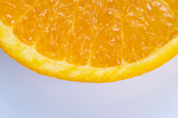 Clean orange slice positioned on pale background showing bright pulp and smooth rind, modern packaging aesthetic with negative space for text and branding, crisp and marketable