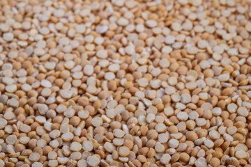 Arranged split peas in kitchen scene, Vibrant yellow peas set against warm kitchen background, Colorful yellow split peas displayed on flat surface for cooking preparation
