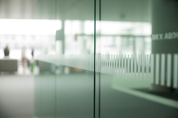 Modern Office Interior with Glass Walls and Frosted Stripes Creating Corporate Workspace Background