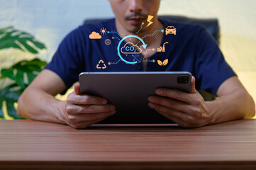 Man Holding Tablet with Digital Icons Representing Environmental Caution