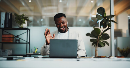 Creative agency, video call and black man with laptop, greeting and virtual meeting for article proposal. African person, editor and journalist in office with tech, webinar and hello or communication © peopleimages.com
