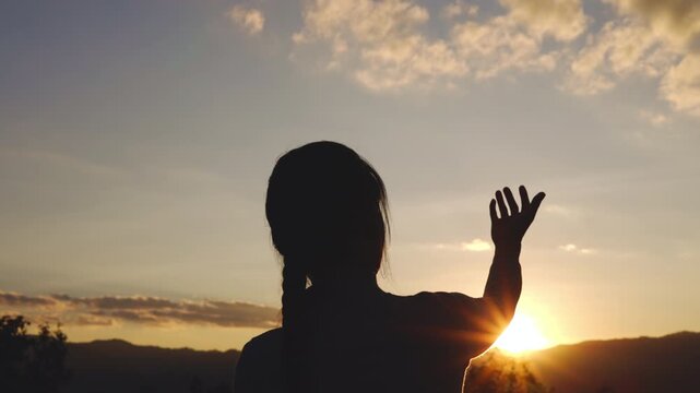 Video 4k Slow motion, Silhouette of woman Praying hands with faith in religion and belief in God On the morning sunrise background. Namaste or Namaskar hands gesture, Pay respect, Prayer position.