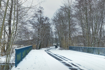 Wintery street with snow and slush - atmospheric winter landscape

