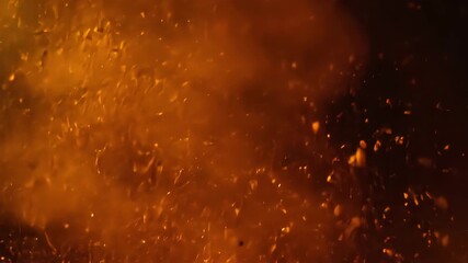 Macro slow motion shot of golden brown powder exploding and dispersing in liquid, creating an abstract, fiery, and energetic background - Powered by Adobe