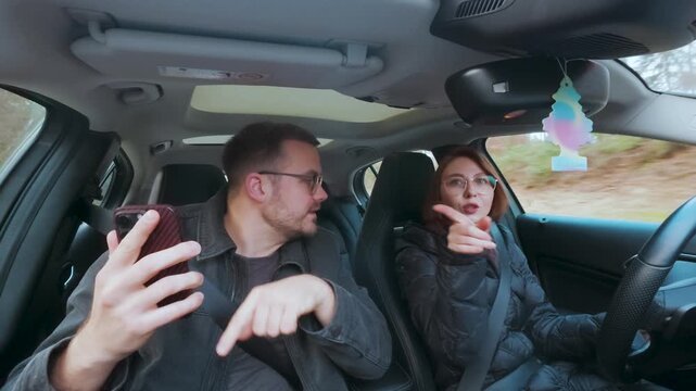 Frustrated couple sitting in a car arguing about navigation and directions &mdash; concept of confusion, miscommunication, and travel stress.