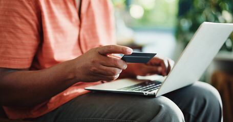 Man, hands and credit card in apartment with laptop, payment and discount promo for online shopping. Person, typing and fintech in house with computer, bank transaction or eft purchase for ecommerce.
