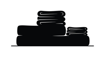 A neatly stacked pile of folded towels presented in a dark striking silhouette © Kuntol02