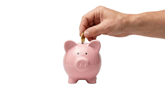 Male hand putting gold coin into pink piggy bank