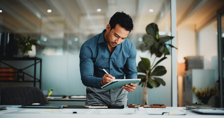 Creative man, tablet and notes in office with stylus for editing, proofreading or publishing in...