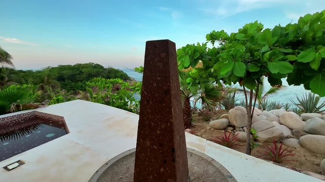 Ornamental obelisk in lush villa gardens, Mexico