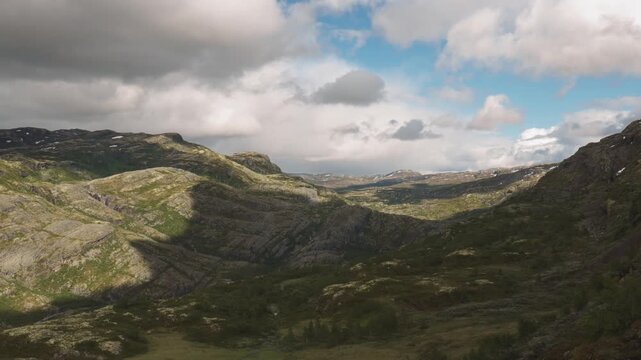 Rolling Mountain Terrain Stretches Beneath Shifting Clouds, Revealing a Vast Highland Landscape at Tusenmeteren, &Oslash;vre &Aring;rdal, Norway - Timelapse