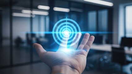 Hand holding glowing blue target with concentric circles in modern office background with futuristic technology and innovation concept with virtual