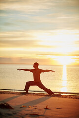 Man, sunset and yoga at beach for exercise, health and wellness outdoor with chakra balance. Yogi,...