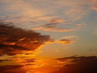 It's the minute before dawn - the sun isn't visible yet, but its rays are already refreshing the lower edges of the clouds against the blue sky.