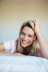 Fototapeta premium Happy, smile and portrait of woman in bedroom for resting, comfortable and wake up in morning. Bed, house and person with calm, pride and relax for health, wellness and peace on weekend in home