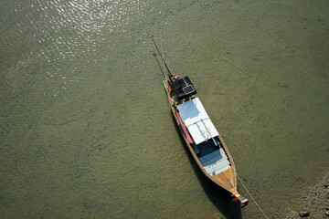 Top view of wooden boat parking at the pier. Fisherman boat floating on the shore