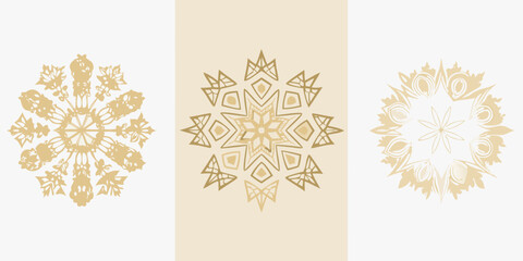 Three golden ornamental snowflake designs on a neutral beige background