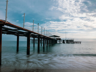 serene sunset scene with an old pier and calm sea