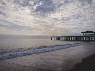 serene sunset scene with an old pier and calm sea