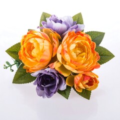 Array of bright artificial orange and purple flowers with green leaves on a bright white surface