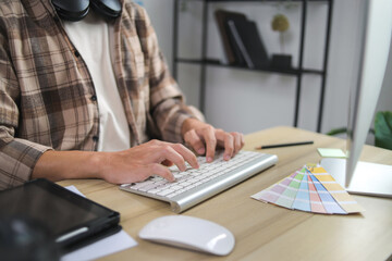 Young Graphic Designer Intensely Focused on His Computer Screen