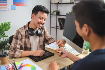 Smiling Graphic Designer Discusses Color Palette Choices With Client in Modern Office