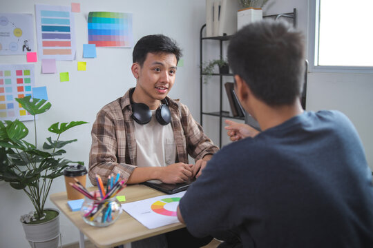 Graphic Designers Collaborating on Logo Concepts, Selecting Colors - Powered by Adobe