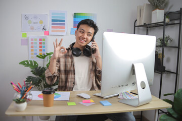 Young Male Creative Professional Confirming Successful Project on Smartphone Call