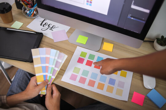 Graphic Designers Collaborating on Color Palette - Powered by Adobe