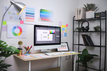 Modern Graphic Design Workspace With Computer Screen Displaying Logo Concept